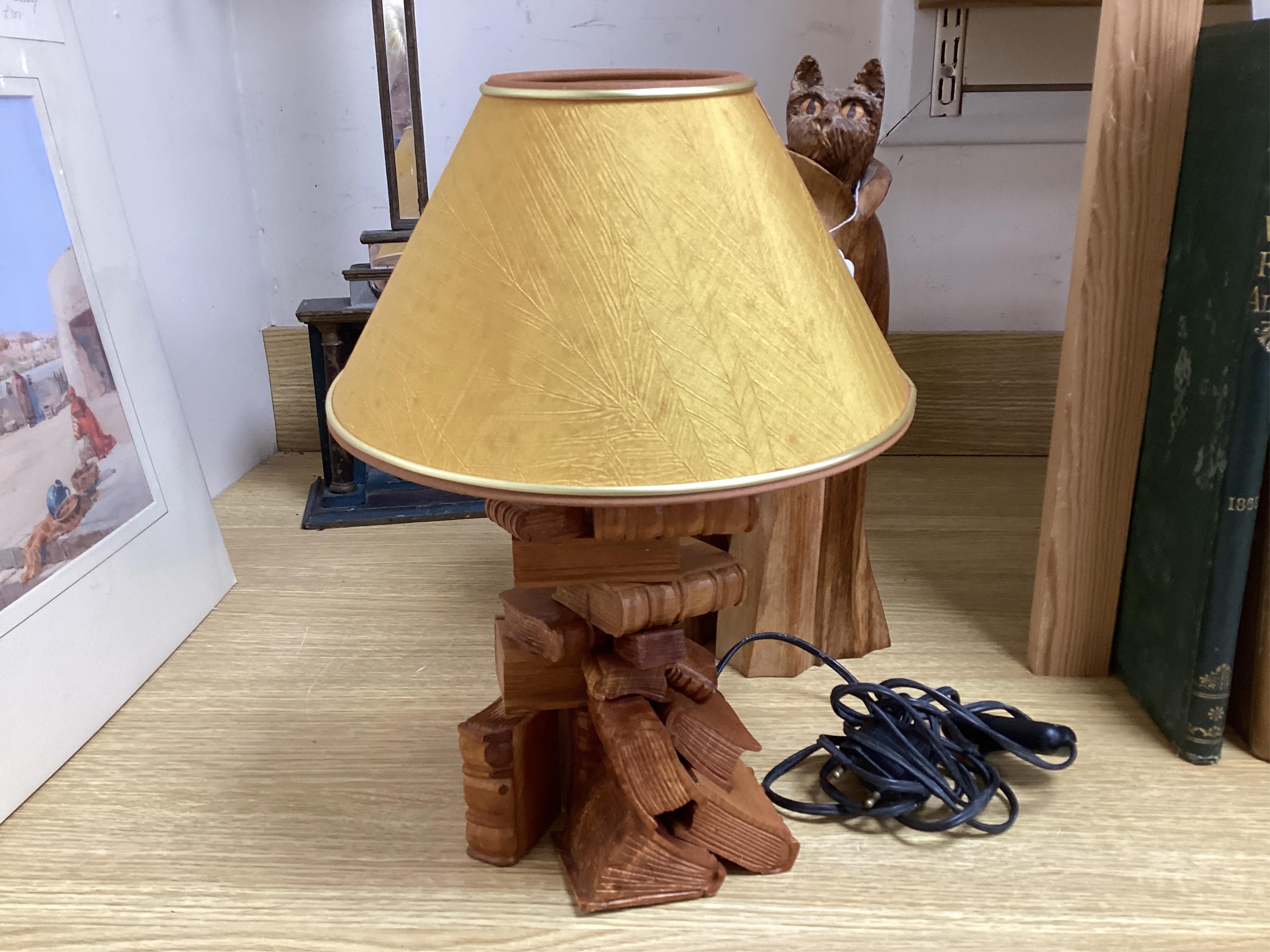 Pierre Decorse (b.1953), a pair of carved hardwood cats and a novelty lamp modelled as a stack of books, with shade, largest overall 36cm high